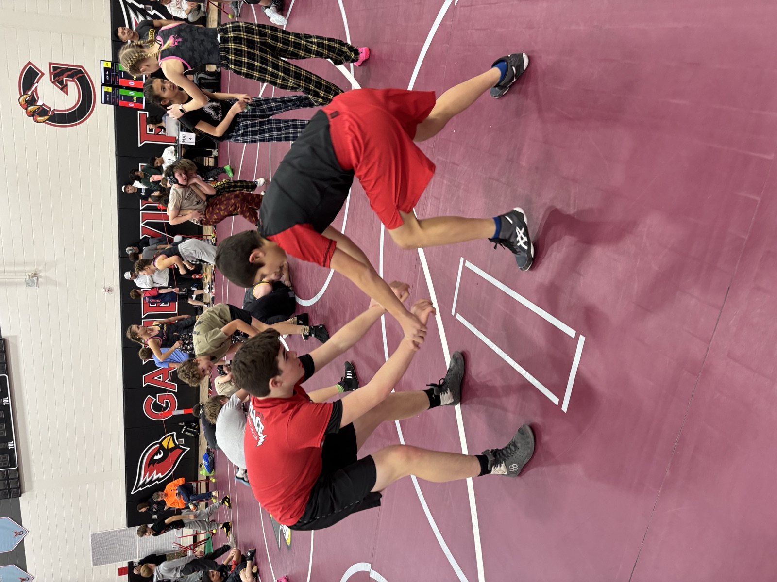 Wrestlers hand-fighting in a drill